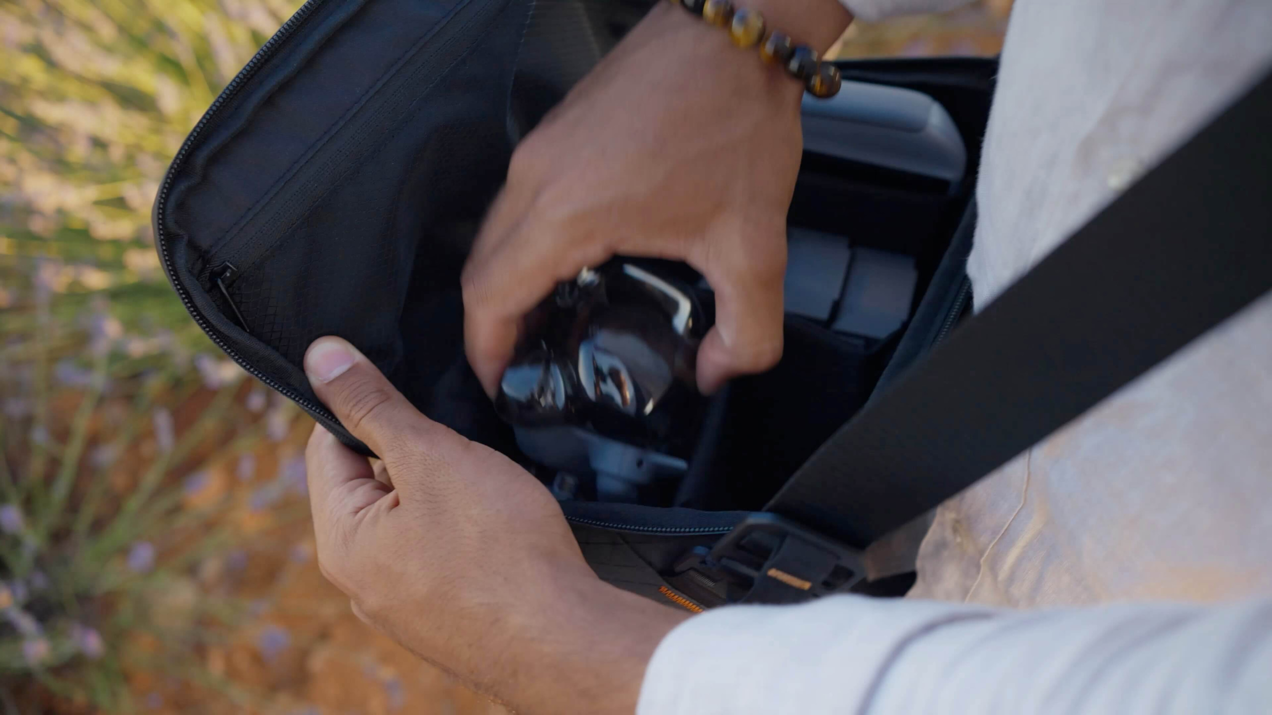 Mit der Mini groß rauskommen Gefaltete DJI Mini 5 Pro wird in die Seitentasche eines Rucksacks gesteckt