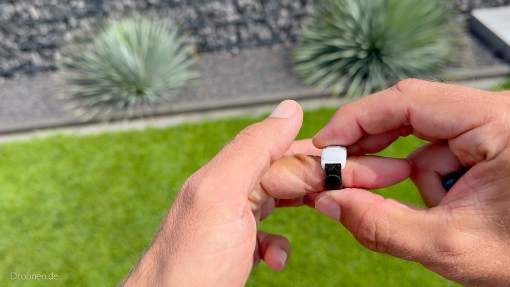 Antigravity Ring Remote wird am Finger angelegt – kleiner weißer Ring mit einer Taste