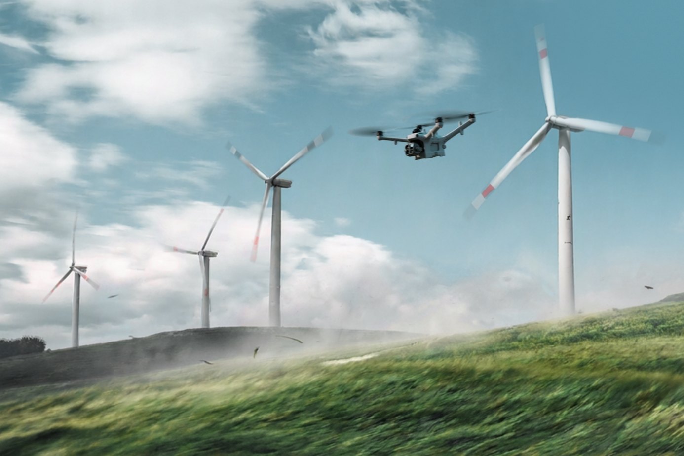 DJI Matrice 5TD fliegt über eine grüne Wiese an Windkraftanlagen vorbei als Einsatzszenario für Inspektion