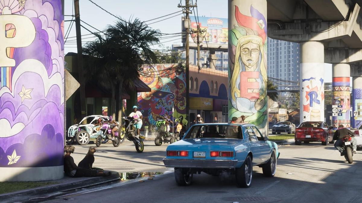 GTA-6-Screenshot einer Straße in Vice City mit Graffiti, Hochbahn und einem blauen Oldtimer