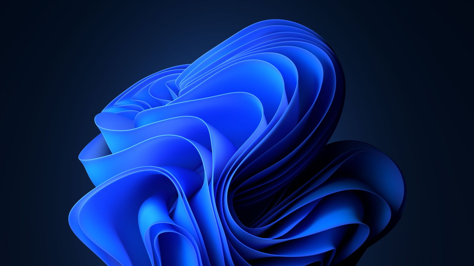 Blaues Bloom-Motiv von Microsoft Windows 11 auf dunklem Hintergrund